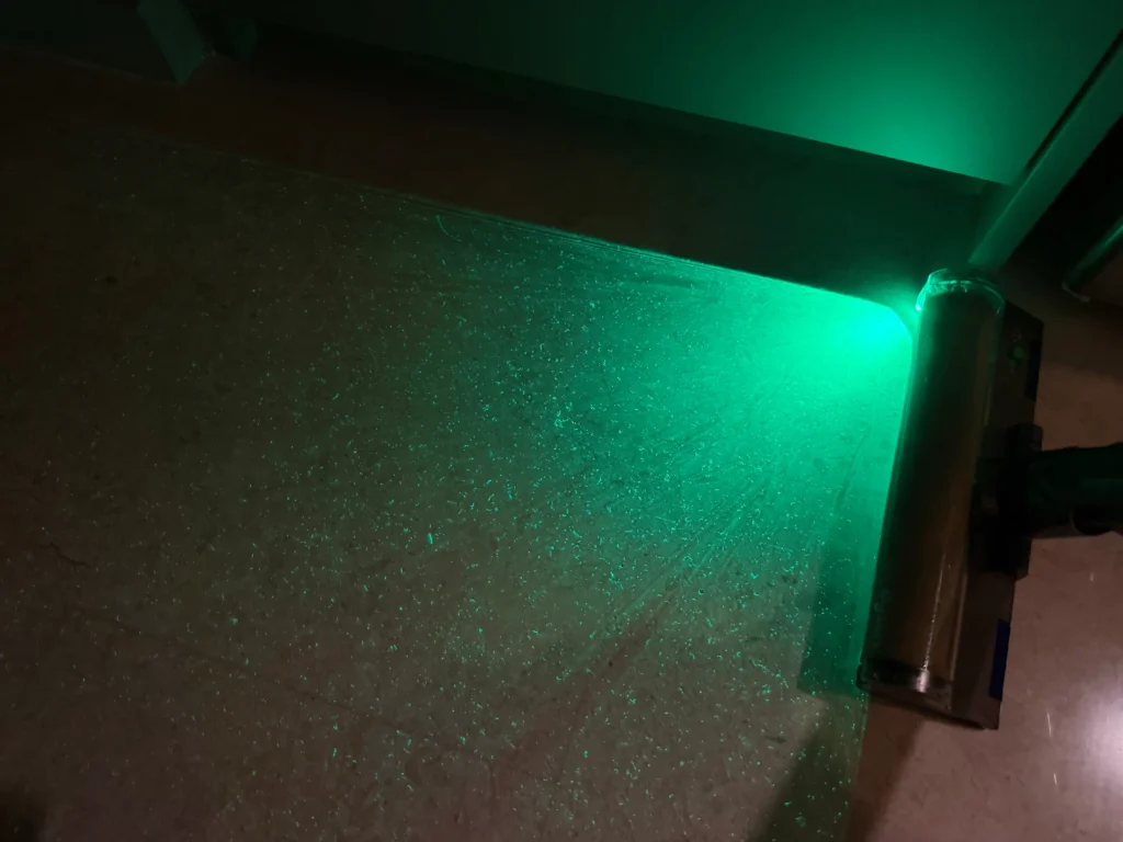 Dyson V12 Detect Slim's light revealing dust particles before Roborock Qrevo C Pro vacuum run